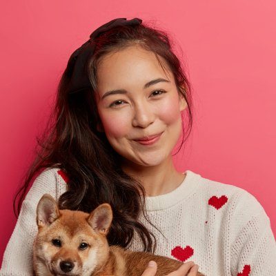A Whiskers Care Company caregiver with a happy pet